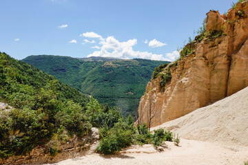 Fototapeta premium Lame Rosse in the Sibillini's mountains. Rock in the shape of pinnacles and towers consisting of gravel held together by clay and silts, formed thanks to the erosion of atmospheric agents.