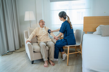 Fototapeta na wymiar Nurse caregiver with senior man using blood pressure tool at home or nursing home.