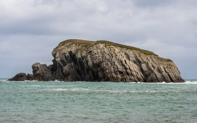 Fototapeta na wymiar Island with flat and inclined rocks