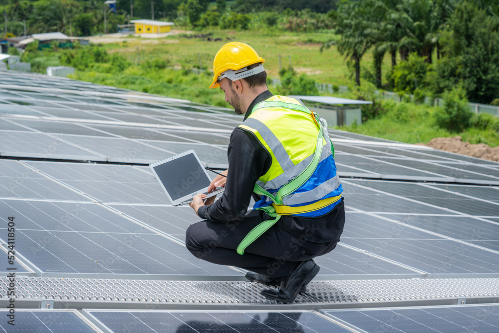 Poster engineers checking solar panel on the roof of factory.