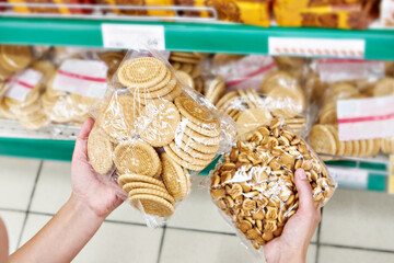 Packets of cookies in hands of buyer
