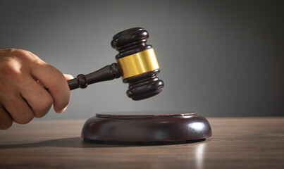 Male judge in a courtroom striking the gavel.