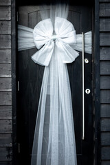 White ribbon on a black door