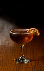 orange cocktail with dried orange garnish 