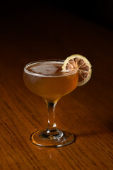 orange cocktail with dried orange garnish 