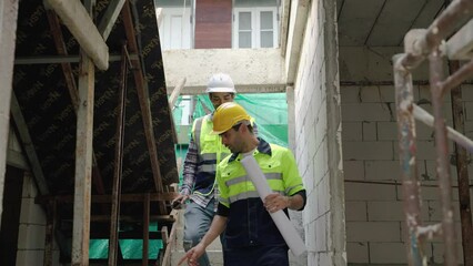 Engineers and foremen are surveying to supervise the work in accordance with the construction plan at the construction site.
