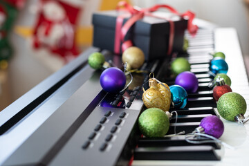 Piano keyboard with Christmas decoration, closeup