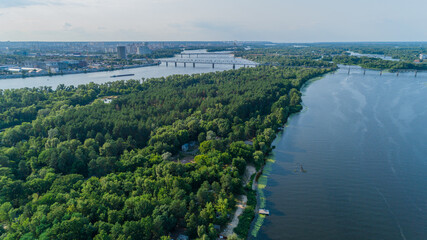 Fototapeta na wymiar Aerial view summer forest and river in sunny day. Drone shot beautiful nature landscape, green trees