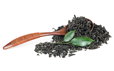 Dried black tea in wooden spoon and fresh tea leaves isolated on a white background