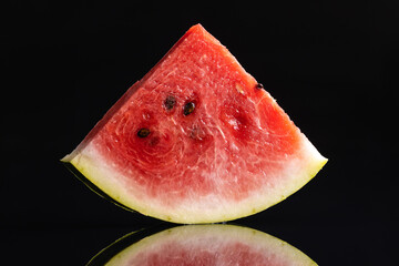 Slices of red watermelon on black background.