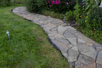 flagstone, sandstone landscaping in a country house, drainage systems and the arrangement of paths...