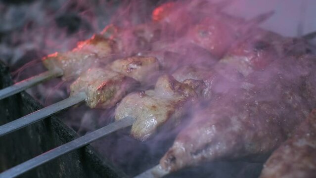 Close-up of lumpy kebab with tomato and ground kebab is grilled on the grill