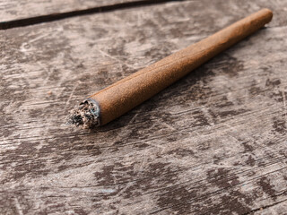 Weed or marijuana joint on a brown wooden table
