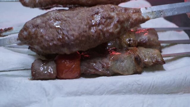 Close-up of ready lumpy kebab with tomato and ground kebab