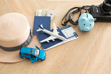 Flat lay composition with passport, toy plane and camera on wooden background, space for text. Visa receiving