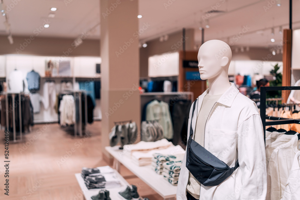 Wall mural view of mannequin in a clothing store background
