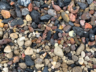 Pebbles on the shore of a lake in a volcanic crater in Askja, Iceland.