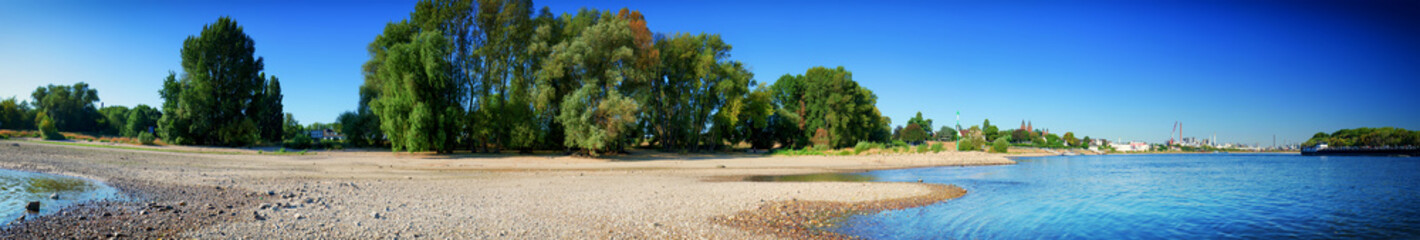 Low water level of the Rhein dry river landscape, panorama photo On the banks of the Rhine dried out in Cologne
