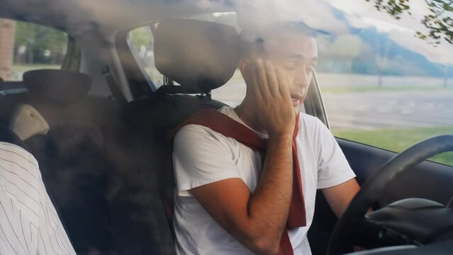 A man and a woman in the car are quarreling and shouting at each other.