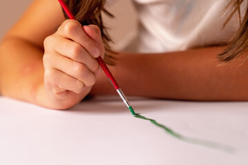 Portrait of beautiful child girl painting the picture. Art concept.  Horizontal image.