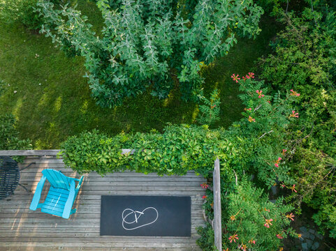 Adirondack Chair, Exercise Mat And Fitness Jump Rope On A Wooden Backyard Deck, Aerial View Of Summer Scenery With Trumpet Vine In Bloom In Colorado