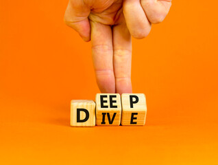 Deep dive symbol. Concept words Deep dive on wooden cubes. Beautiful orange table orange background. Businessman hand. Deep dive and business concept. Copy space.