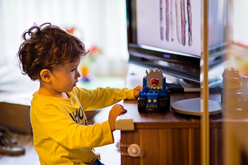 Baby boy playing with construction toy blocks at home. Kids playing. Children at day care. Child and toys