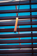 Cylindrical light fixture hanging from a ceiling
