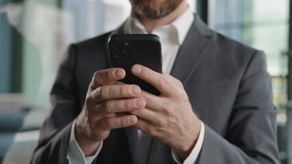 Closeup male hands unrecognizable unknown Caucasian man professional worker businessman holding cellphone mobile phone texting typing chatting in social networks receive message web surfing online app