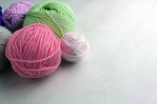 Yarn and balls for knitting, on table