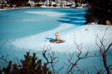 Stone lantern statue on a frozen penninsula