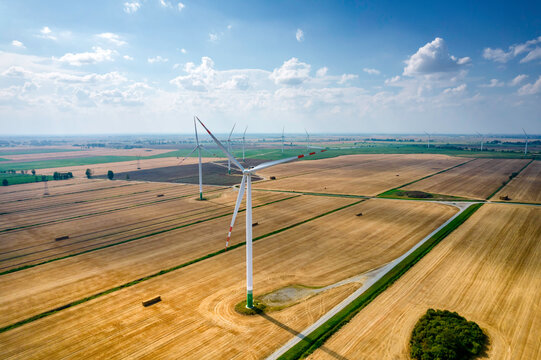 Wiejski krajobraz z wiatrakami. Energia odnawialna w Polsce. Prąd z wiatru. Elektrownia wiatrowa.