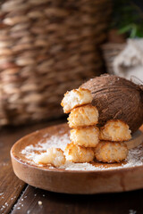 Coconut cookies. Homemade gluten free pastry with coconut. Small round sweets on a wooden table. High quality photo. Copy space