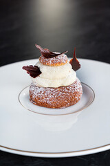 tasty cake with vanilla cream on white plate
