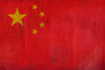 Full frame front view photo of a weathered flag of China painted on a rusty, grunge and dirty wall.