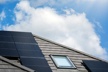 Solar panels on the house roof in sunny day. Renewable clean green energy generation.