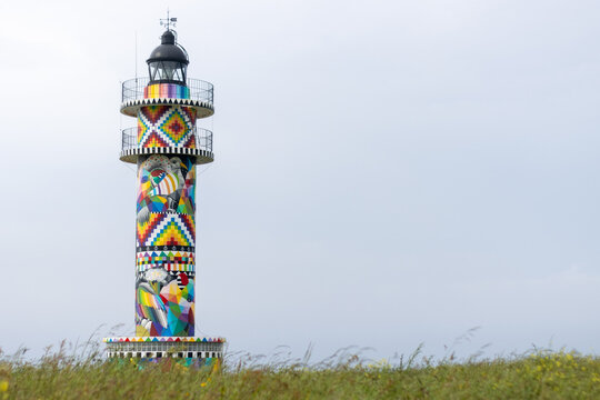Cabo de Ajo Lighthouse painted by the painter Okuda San Miguel, specialized in Urban Art. Ajo, Bareyo Municipality, Cantabria, Cantabrian Sea, Spain, Europe