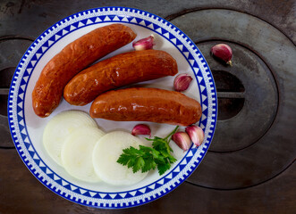 Closeup of pepperoni sausage on plate.