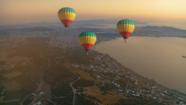 aliaga gulf aerial view at sunset time with hot air baloons