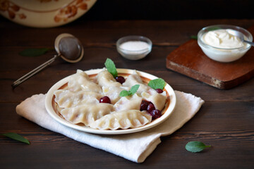 ukrainian national dish dumplings with cherries, traditional serving in rustic style