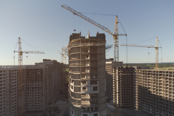 Construction of a new residential area. Multi-storey panel houses. Several cranes