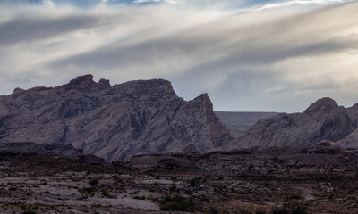 Rugged Mountain Rock Formations in the desert with dramatic clouds at sunset. Utah, United States of America. Nature Background.