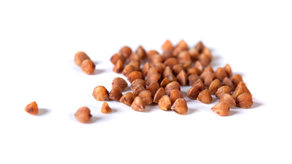 Pile of buckwheat seeds isolated on white background, closeup