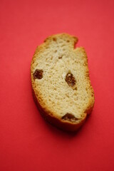 Cracker with raisins on a red table, top view