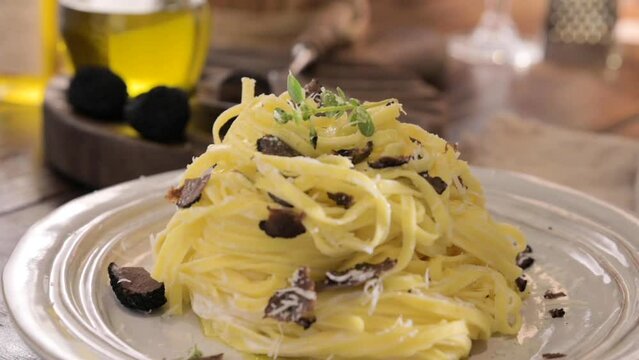  Black truffle on tagliatelle pasta. Expensive lunch, homemade pasta, traditional in the Lazo region of Italy. High quality FullHD footage