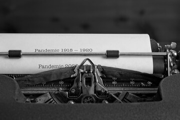 Pandemic 2020  concept with mechanical typewriter printing out ‘Pandemic 1918 - 1920’ followed by  ‘Pandemic 2020 - ?’