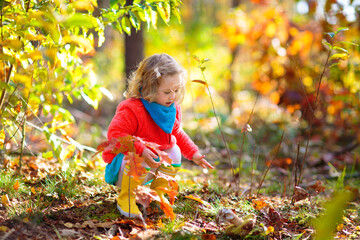 Kids play in autumn park. Children in fall forest.