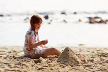 Little girl playing on tropical beach