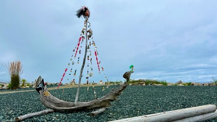 Handmade ship made from dry branches Seashell beads and a pirate flag Against the backdrop of the...
