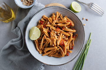Healthy pasta with tomatoes and pine nuts